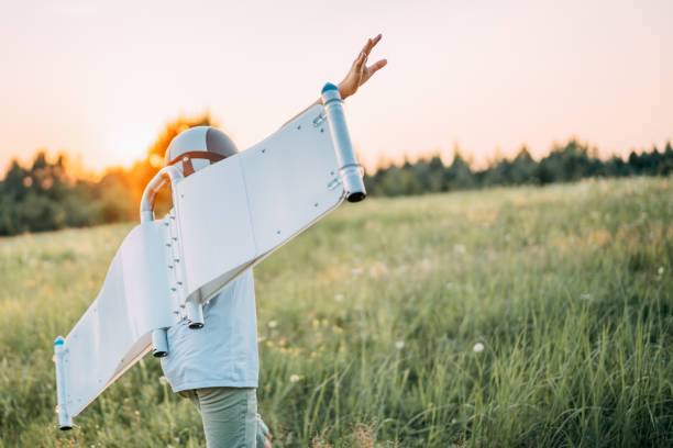 istock Boy wearing jetpack wings playing. Dream of flying. 1272608566