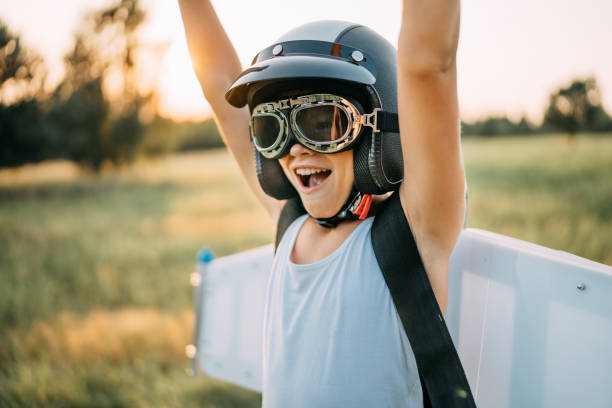 istock Boy wearing jetpack wings playing. Dream of flying. 1272609121