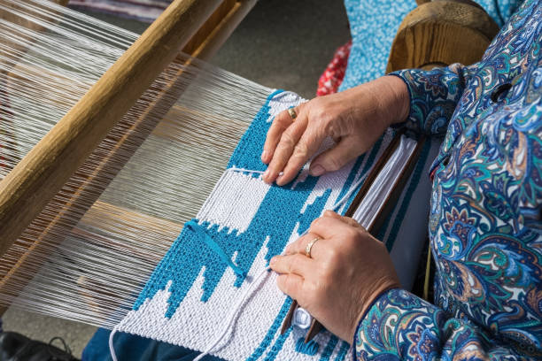istock Woman hand weaving on manual loom. 1272610517