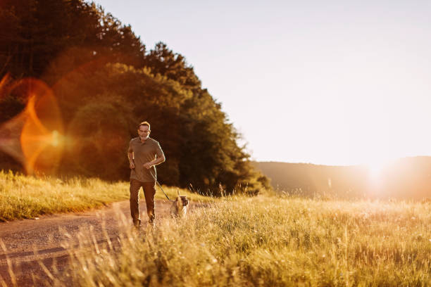istock Senior man walking his dog 1272612538