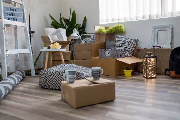 istock Packed cardboard boxes and stuff during moving into new home 1272612624