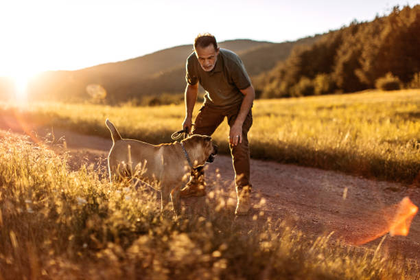 istock Senior man walking his dog 1272613630