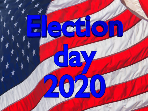 istock Election day 2020 writing with US flag on the background 1272614850