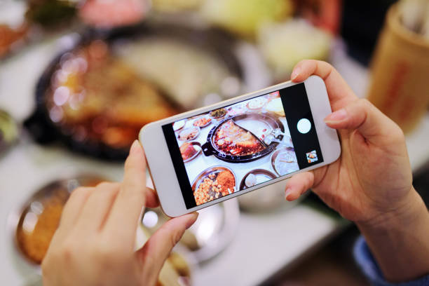 istock Using phone to take photo of food. 1272615401