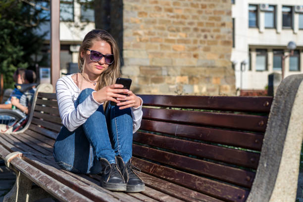 istock Young Girl With A Iphone. Chat by phone. New technologies. 1272616839