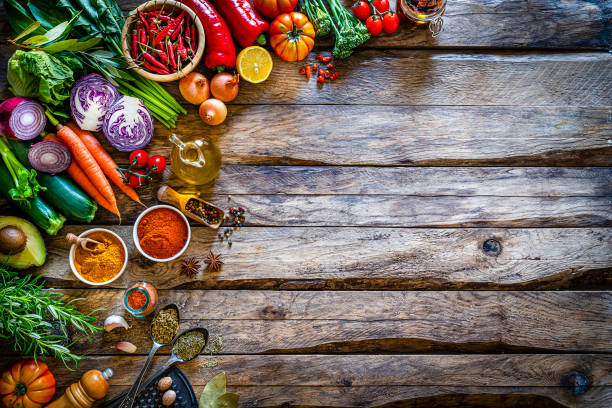 istock Multi colored vegetables and spices on rustic wooden table. Copy space 1272616900