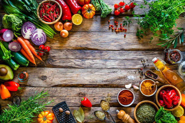 istock Multi colored vegetables and spices border on rustic wooden table. Copy space 1272617141