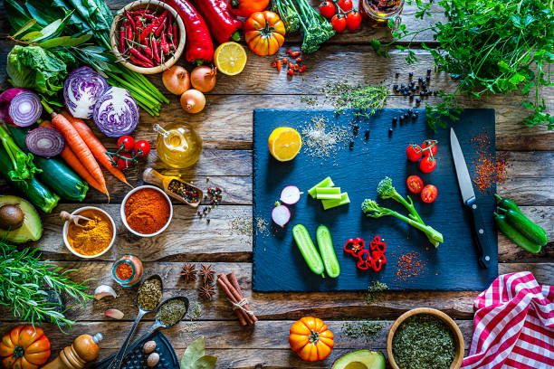 istock Multi colored vegetables and spices border on rustic wooden table. 1272617316