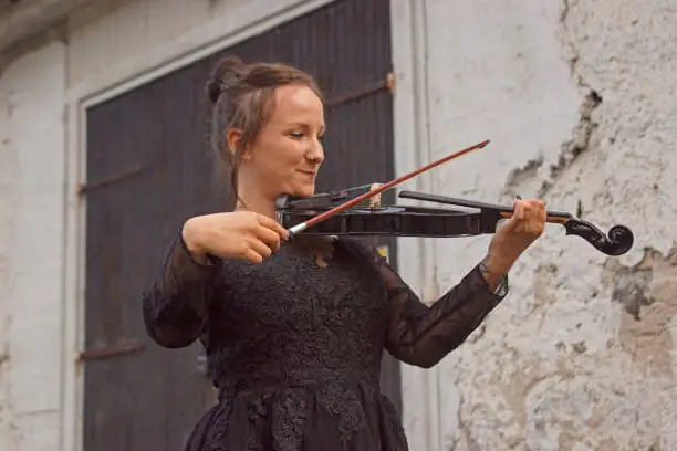 Beautiful young woman playing violin