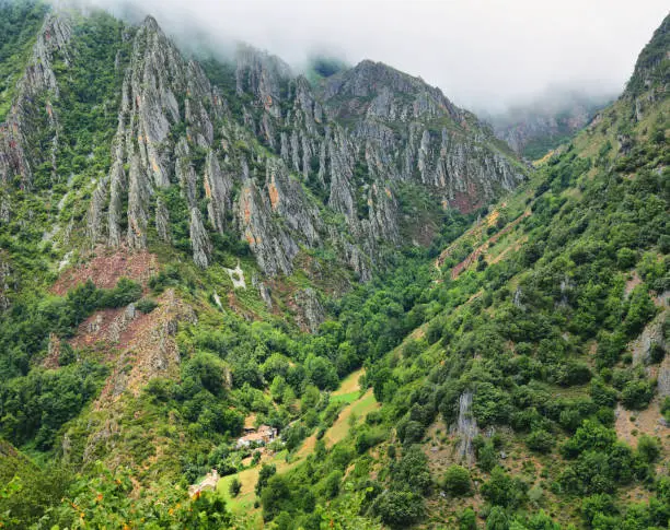 View of valley with craggy mountains near Pola de Somiedo Village, Somiedo nature reserve, Asturias, Spain