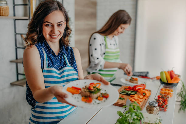 istock Young women preparing food in the kitchen 1272626115