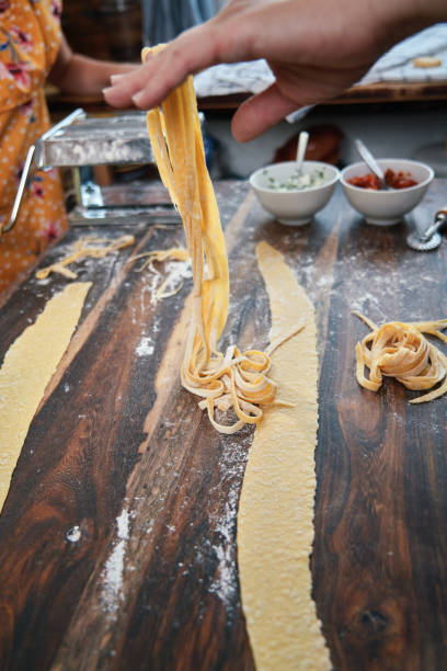 istock Cute Girls Preparing Pasta in Domestic Kitchen 1272627437