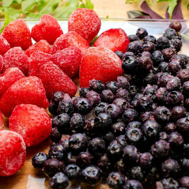 istock Frozen strawberries and blueberries 1272627842