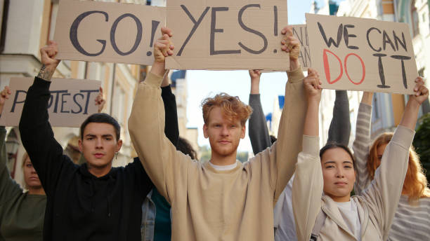 istock Silent protest multiracial student activists with posters at city streets. Mass protest concept 1272629617