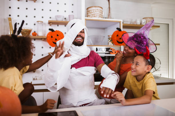 istock Happy family preparing for Halloween, having fun. 1272629930