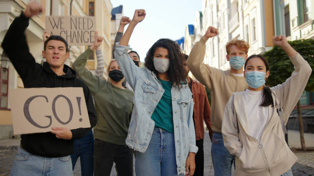 istock Multiracial protest demonstration, protesters wearing medical masks. 1272629991
