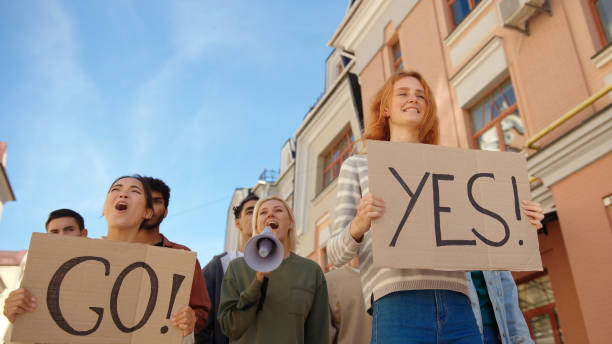 Happy protesters with Go and Yes placards celebrate victory