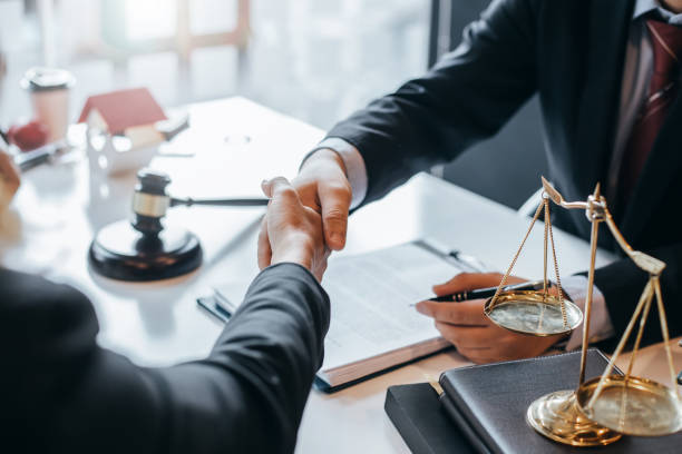 Lawyer who provides legal advice in the office. Businessman and lawyer shaking hands. stock photo