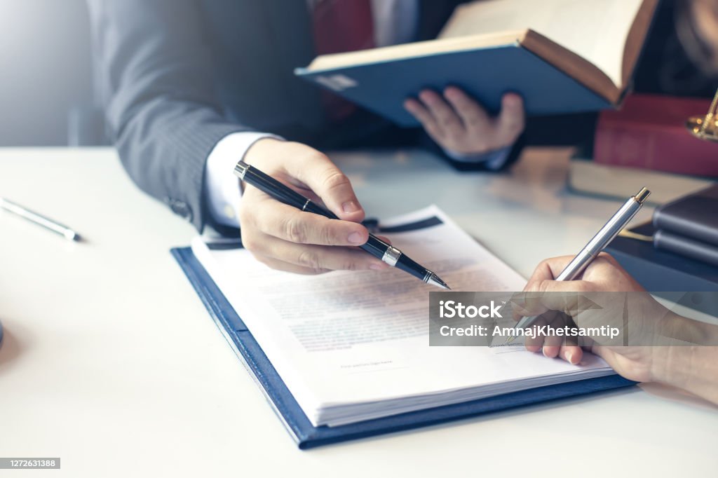 Lawyer pointing to the form signing of the contract agreement. Contract Stock Photo