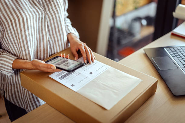 istock Businesswoman reading the barcode with the mobile phone app 1272631903