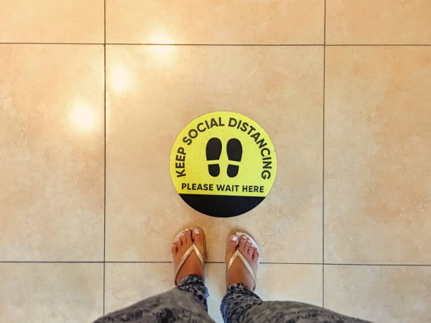 istock Social distancing floor marking stickers on queue line 1272631995