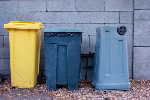 istock Three large old plastic trash cans in the back yard of a home 1272632114