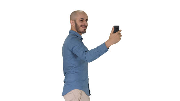 istock Happy smiling handsome young man making selfie while walking on white background 1272633353