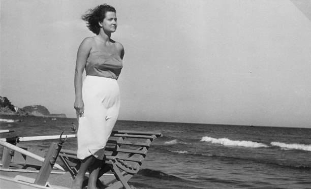 1930s. alassio liguria italy. young woman posing at the beach - young women 20s people one person imagens e fotografias de stock