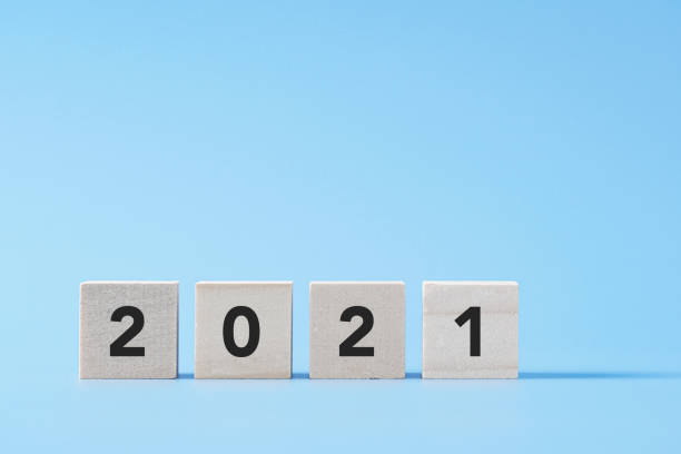 New Year concept with 2021 text on wooden cube block, background with copy space