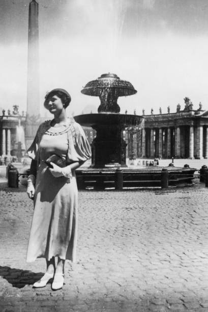 Elegant dressed  lady having fun visiting Rome in the 1930s. Italy. Elegant dressed lady having fun visiting Rome Piazza San Pietro in the 1930s. Vatican city, Italy. church of san pietro photos stock pictures, royalty-free photos & images