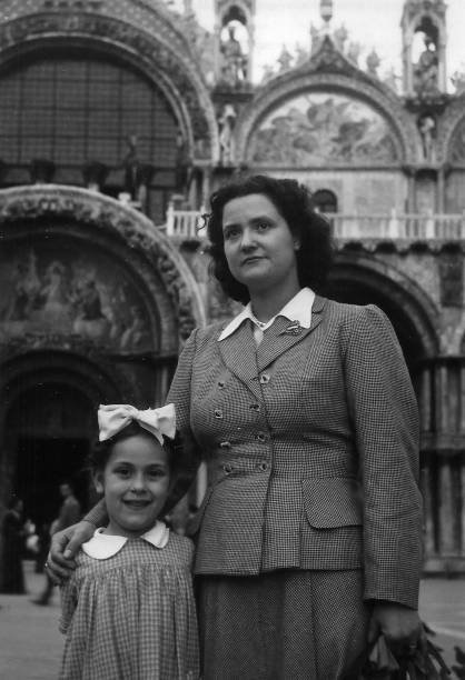 istock Elegant dressed lady having fun visiting Venice in the 1940s.Italy. 1272635944