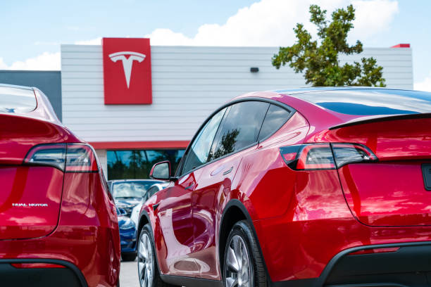 Tesla Motors Austin, TX, USA - September 15, 2020: Two Red Tesla Model Y vehicles and the Red Tesla sign on the front of the building in Northwest Austin Texas location tesla model 3 stock pictures, royalty-free photos & images