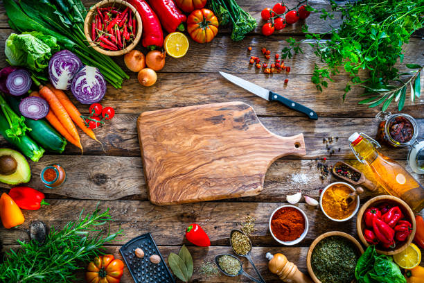 istock Multi colored vegetables and spices border on rustic wooden table. Copy space 1272637392