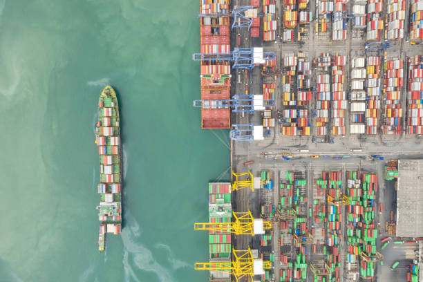 istock Container , container ship in export and import business and logistics. Shipping cargo to harbor by crane. Water transport International. Aerial view and top view. 1272639571