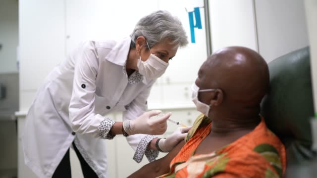 Nurse giving a vaccination shot to a patient
