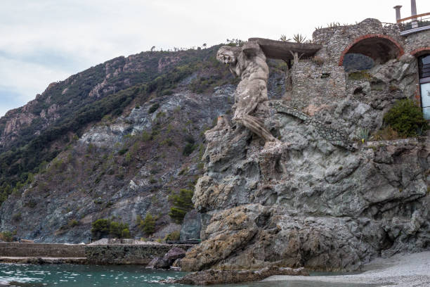 Monterosso al Mare, Italy - July 8, 2017: View of Il Gigante Statue at the Monterosso al Mare Beach, Cinque Terre