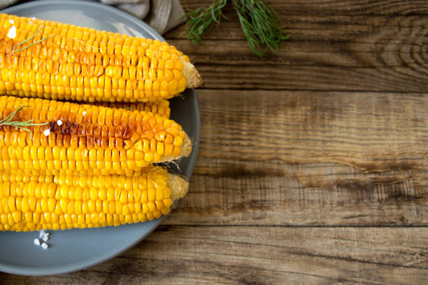 istock grilled corn, boiled corn on a wooden background. 1272642414