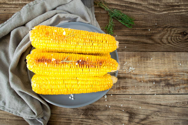 istock grilled corn, boiled corn on a wooden background. 1272642485