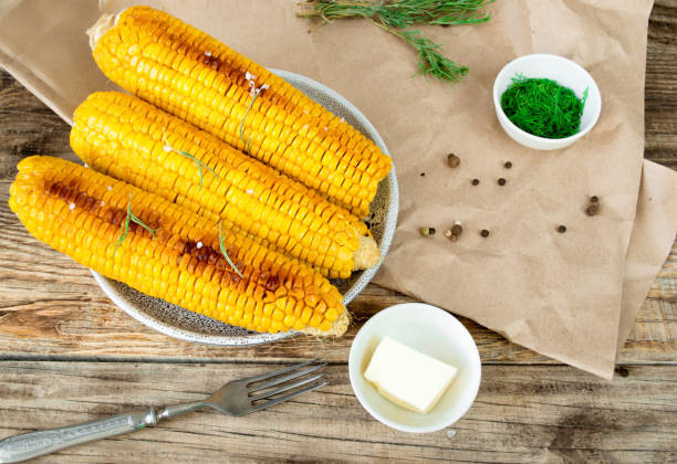istock grilled corn, boiled corn on a wooden background. 1272642603