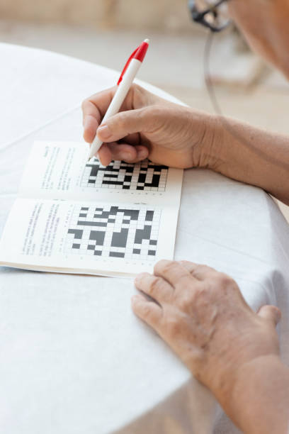 istock Senior Woman Doing Crossword Puzzle 1272643143