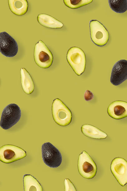 istock Avocado. Background made from isolated Avocado pieces on olive color background. Flat lay of fresh ripe avocados and avacado pieces. 1272645075