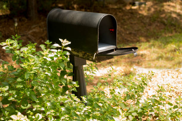 Empty open mailbox beside a rural road. Empty open mailbox beside a rural road.  Tranquil scene. united states postal service photos stock pictures, royalty-free photos & images