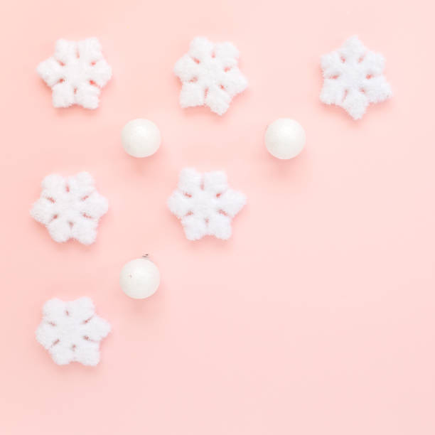 istock Christmas frame with white christmas snowflakes on pink background. Christmas composition, wallpaper. Flat lay, top view 1272648966