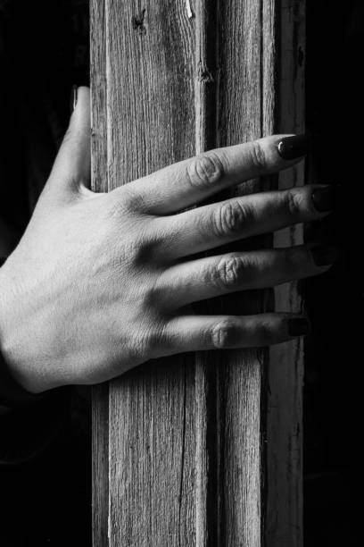 istock female hand on a wooden pillar 1272651298