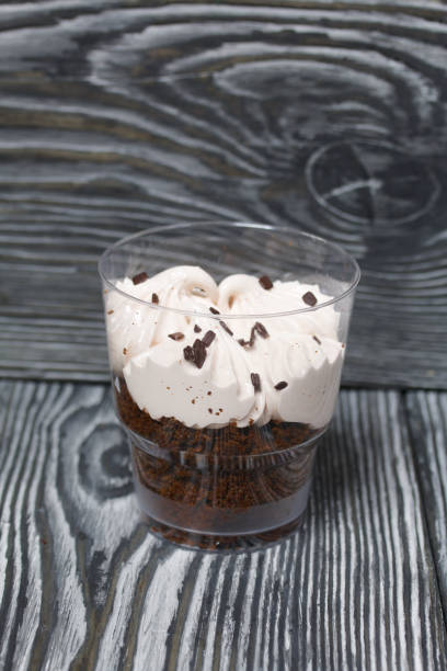 istock Zephyr in a glass. With biscuit and chocolate. On pine boards painted black and white. 1272651463