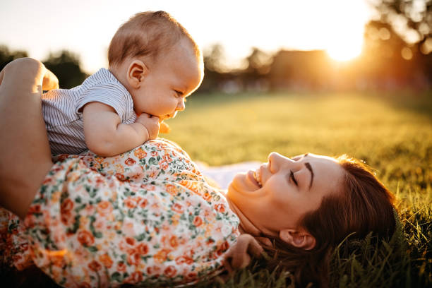 istock Mother and baby laying down in meadow 1272665951