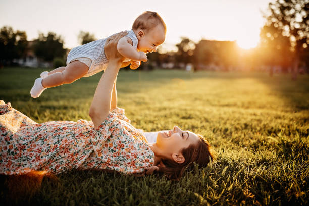 istock Mother and baby laying down in meadow 1272666171