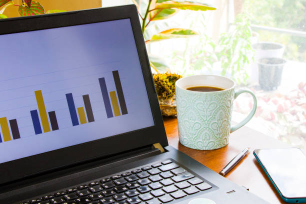 istock Workspace at home, notebook, mobile device, coffee and plants on the table, laptop desktop 1272667610