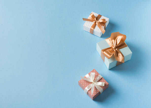 istock Gift boxes with ribbon flat lay on blue pastel background 1272667769