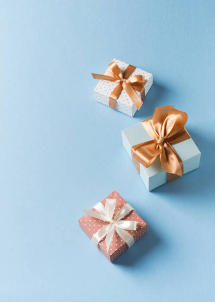 istock Gift boxes with ribbon flat lay on blue pastel background 1272667773